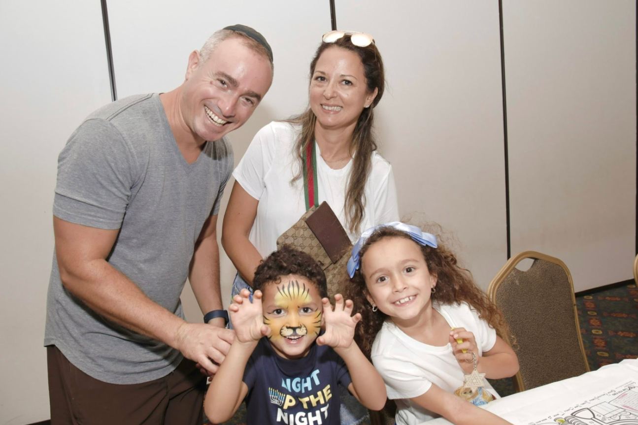Parents with their two young children at a holiday celebration